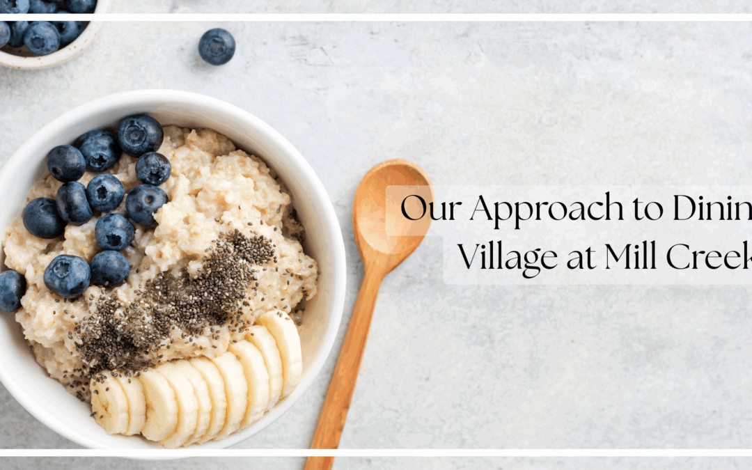 Bowl of oatmeal topped with blueberries, chia seeds, and banana slices on a light background with the text 'Our Approach to Dining at Village at Mill Creek'