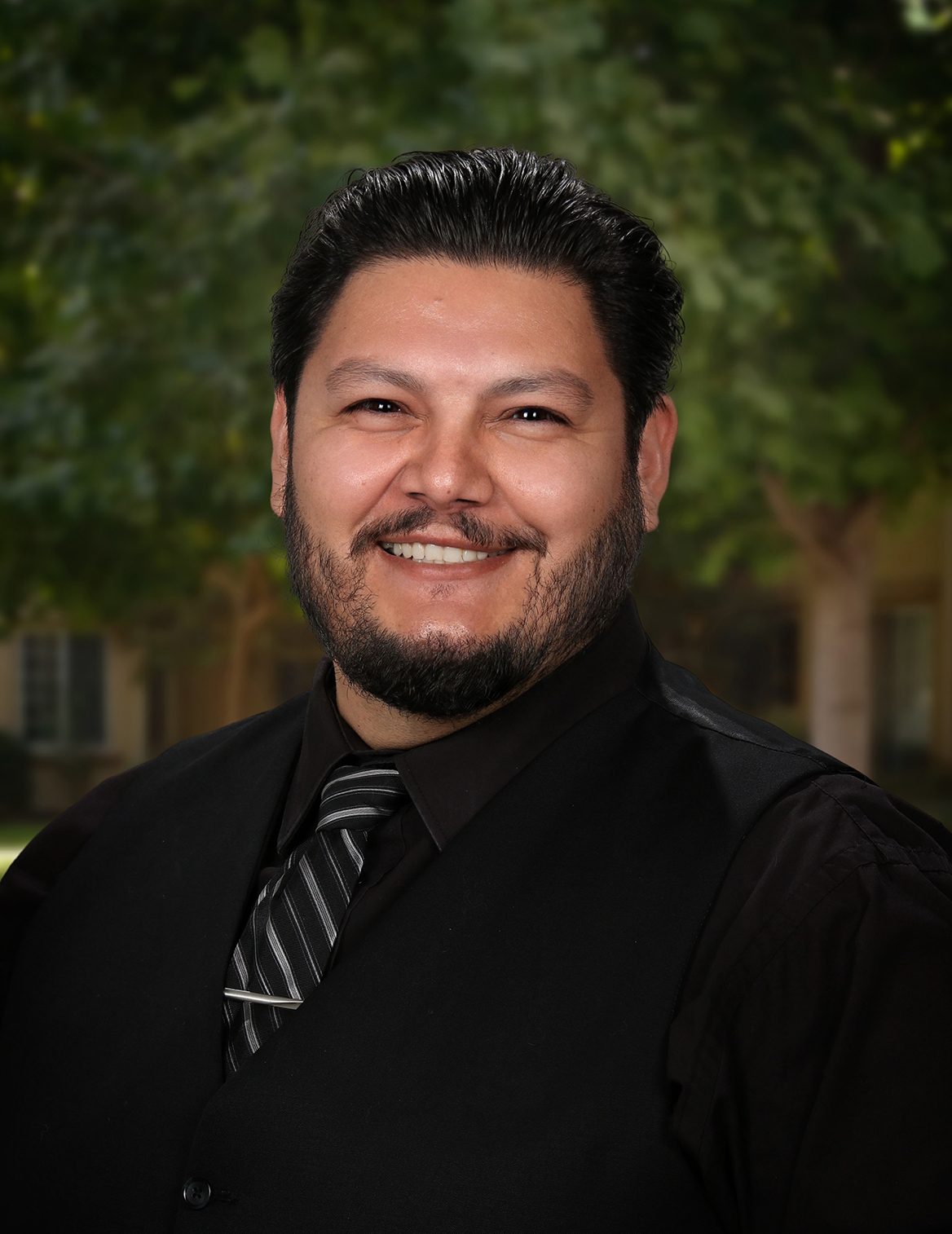 Portrait of man smiling gus chavez our executive director
